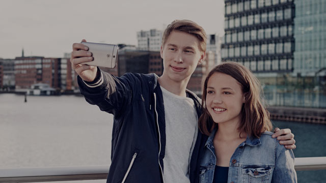 young couple taking a selfie small overlay