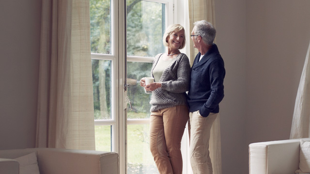 Older couple standing by the window