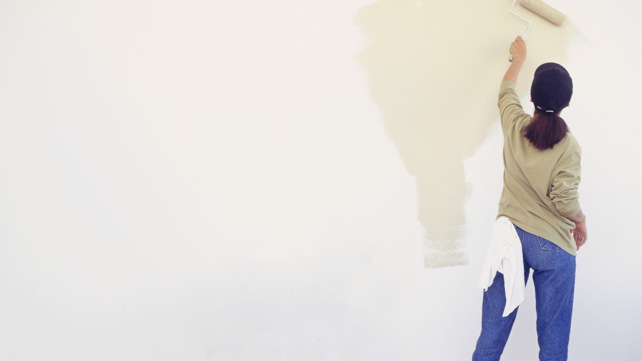Woman painting on the wall