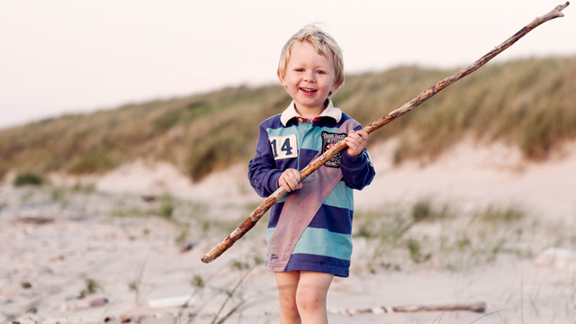 Child balance on the beach summertime