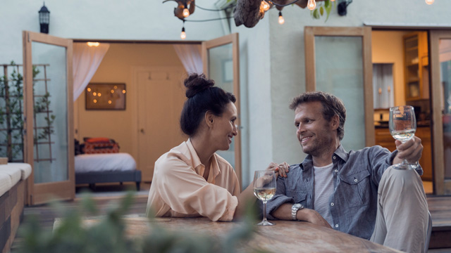 Couple enjoying a glass of wine indoors -small
