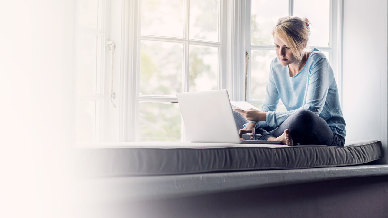 Woman in window with laptop