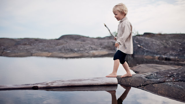 Boy playing by the water SMALL