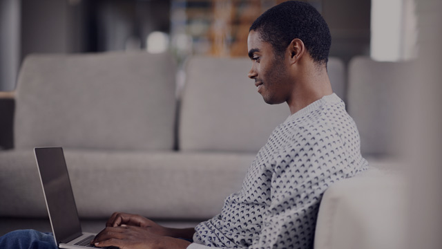 Man looking at laptop small overlay