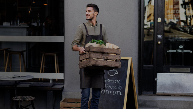 business owner in front of shop small overlay