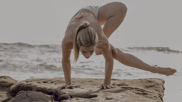 woman practicing yoga on the beach small overlay