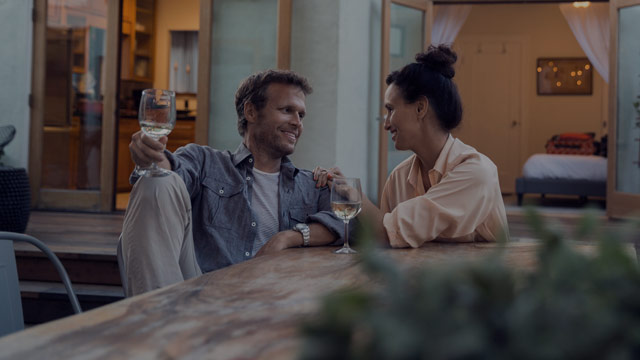 couple talking and drinking on patio small overlay