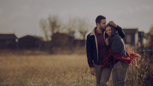 couple walking in field small overlay