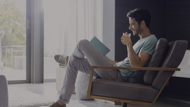 man drinking tea and reading book small overlay