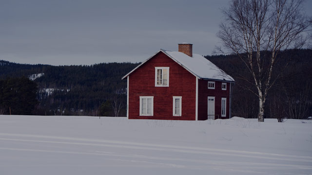 Red wooden house in a winter landscape small overlay