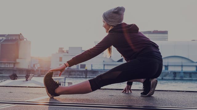 Young woman stretching small overlay